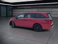The 2025 Honda Odyssey Black Edition in a striking Red finish, equipped with a Front-Wheel Drive, of... (image 5)