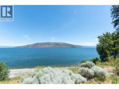 Stunning Unobstructed Lake & Mountain Views! This 0.34-Acre Semi-Waterfront Lot In The Sought-After...