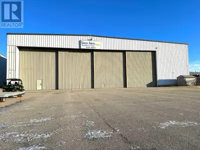 Clear span hangar with 29' High x 129' wide automatic sliding hangar door right at Grande Prairie ai...