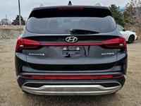 The 2022 Hyundai Santa Fe Hybrid Preferred in sleek Black with an AWD drivetrain offers balanced han... (image 5)