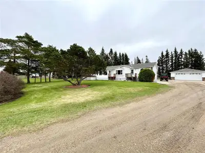 R31//Angusville/Peaceful and practical, this beautifully maintained acreage offers the ideal blend o...