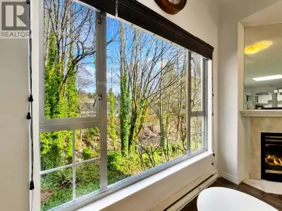 Rare find at The Gables. Top-floor corner suite with serene creek and park views. Enjoy privacy, nat...