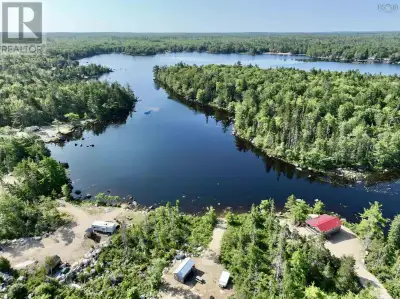 Discover 4.32 acres of possibility with 129 feet of coveted lake frontage on the ever-popular Sandy...