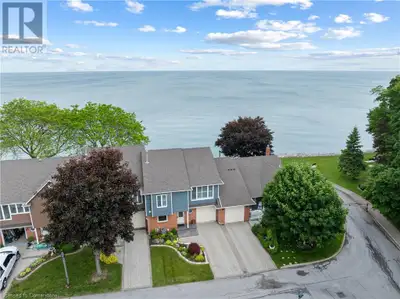 WATERFRONT TOWNHOME WITH PANORAMIC LAKE VIEWS! Step into lakeside living at its finest—where modern...