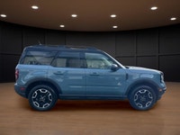 The 2021 Ford Bronco Sport Outer Banks in a striking blue finish with its capable 4x4 drivetrain off... (image 4)