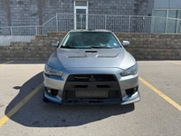 This 2014 Mitsubishi Lancer Evolution delivers pure performance with its turbocharged 2.0L engine, a... (image 1)