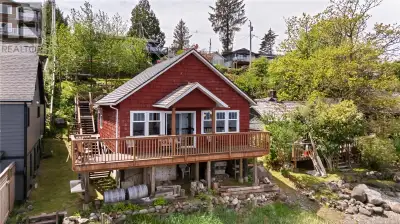 Charming waterfront home with foreshore lease, located at 1412 Imperial Lane in Ucluelet, offering a...