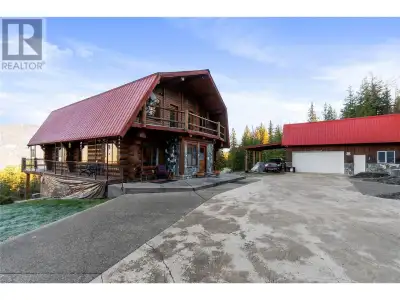 Perched atop the property, this beautifully crafted log home offers unobstructed north-facing views...