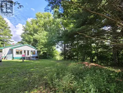 Welcome to 8084 Hwy 311. This peaceful 3.6 acre lot runs along the Waughs River and includes walking...