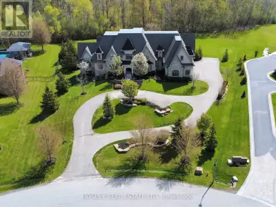 Set in a quiet enclave of prestigious homes, this exceptional 11,500 sq. ft. estate (including built...