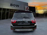 The 2023 Nissan Armada 4x4 Platinum in a striking black finish is a powerhouse SUV designed for both... (image 4)
