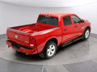 Introducing the Ram 1500 Classic Express 4x4 Crew Cab, a striking red truck that blends power and ca... (image 9)