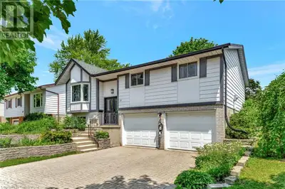 Welcome to this beautifully renovated raised bungalow, ideally situated on a charming tree-lined str...