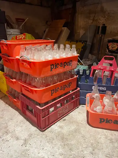 Bottles with cases from a popular old Winkler grocery store called West End Grocery or “The Pic a Po...