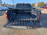 The 2026 Ram 1500 Rebel Crew Cab in Granite Crystal Metallic makes a bold statement with its rugged... (image 5)