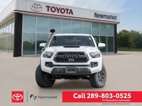 The 2019 Toyota Tacoma TRD Off Road 4x4 Double Cab V6 in a stunning white color with a robust 4x4 dr... (image 1)