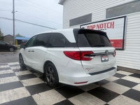 A spacious family minivan with comfortable seating, advanced safety features, and practical convenie... (image 5)