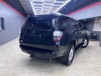 Experience the rugged elegance of the 2016 Toyota 4Runner SR5, presented in a commanding Black finis... (image 2)
