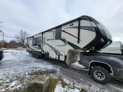 2015 Grand Design Momentum 385TH Toy Hauler fifth wheel trailer. It is approximately 43 feet long, w...