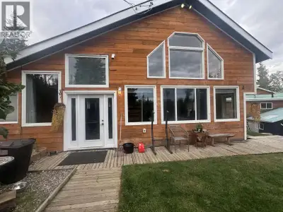 Welcome to this beautifully landscaped acreage, just minutes from city amenities and schools. This s...