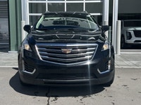 The 2019 Cadillac XT5 Luxury AWD, finished in black with a black leather interior, offers a refined... (image 1)