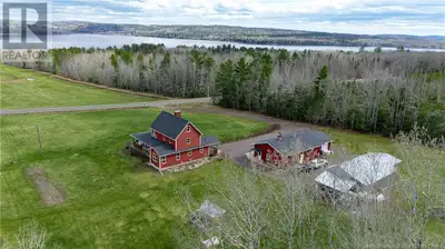 Perched in peaceful countryside with sweeping views of Washademoak Lake. Step into old world farmhou...