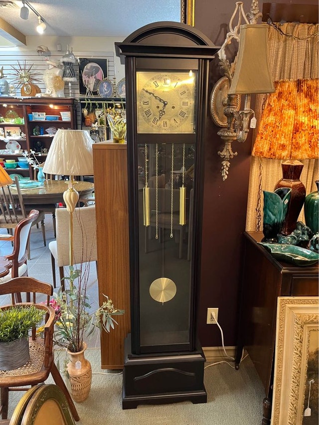 grandfather clock! Dark brown in colour and a gold face Arts & Collectibles Calgary