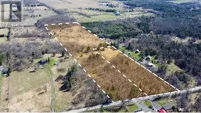 Escape the city and embrace the beauty of country living with this stunning 21.53-acre parcel locate...