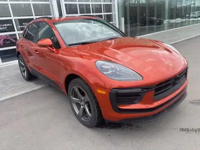 The 2023 Porsche Macan AWD, finished in eye-catching Papaya Metallic, brings true sports car DNA int...