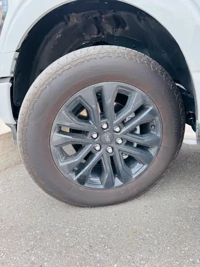 Selling a full set of OEM Ford F-150 20-inch black alloy wheels with Hankook Dynapro AT2 M+S all-ter...