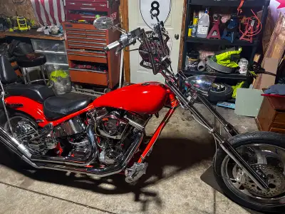 This unique orange chopper motorcycle is a 2000 rolling thunder with a ultima performance 127 fishta...