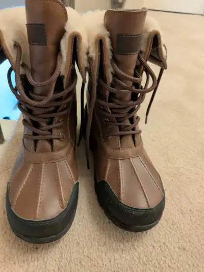 These are brown leather UGG winter boots, perfect for braving the cold in style! These boots are new...
