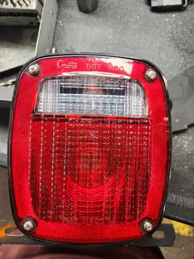 Set of square grote tailights with back up light built in and mounting bracket included. New.