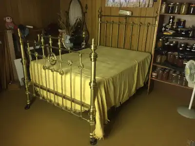 Antique Simmons & Company Brass Bed on Casters Approximately 7' long x 56" wide. Headboard 64" x 54"...