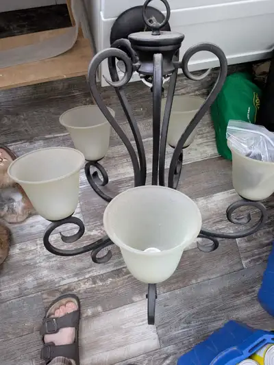 Add a touch of elegance to your home with this beautiful five-bulb chandelier, featuring a wrought i...