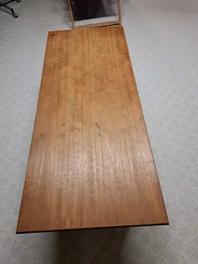 This is a used teakwood coffee table featuring a durable top and a sleek design, perfect for adding...