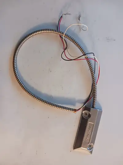 For sale a Sentrol Model 2204-A Overhead Door Contact Switch W/Armoured Cable. Tested OK.