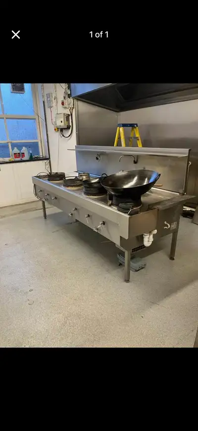Offering a used commercial wok, equipped with high-powered burners for authentic Asian cuisine. This...