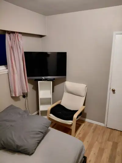This cozy and well-lit room for rent offers a comfortable living space, featuring a bed, a relaxing...