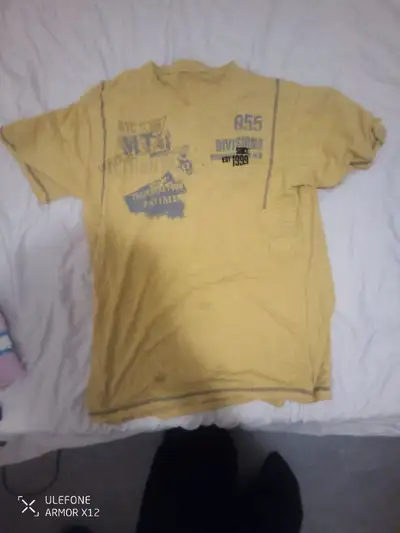 This yellow men's t-shirt, size M, features a unique graphic design, making it a standout casual pie...