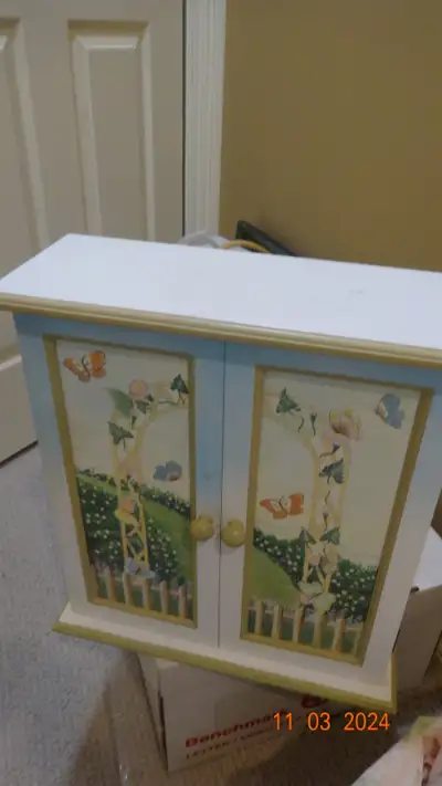 Beautifully decorated cabinet, two doors, one shelf , medicine ? Need to add on hooks to item to han...