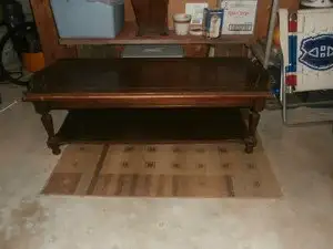 2 tier solid coffee table (brown) top tier is 55" x 22" x17" bottom tier is 46" x 17" and is 3" off...