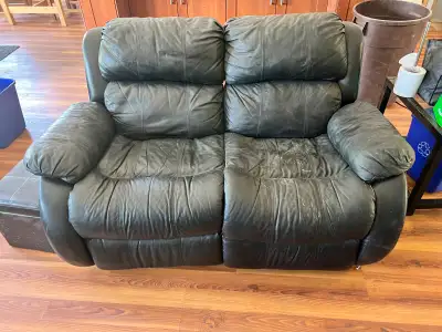 FREE black leather couch and loveseat. Reclining! Love seat in pretty good shape, couch has one cush...