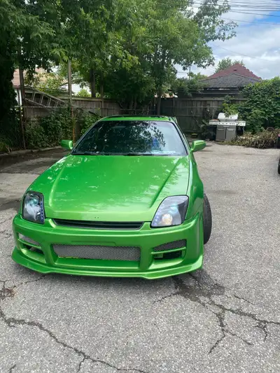 This vibrant 1997 Honda Prelude is a striking head-turner, featuring a custom bright green exterior...