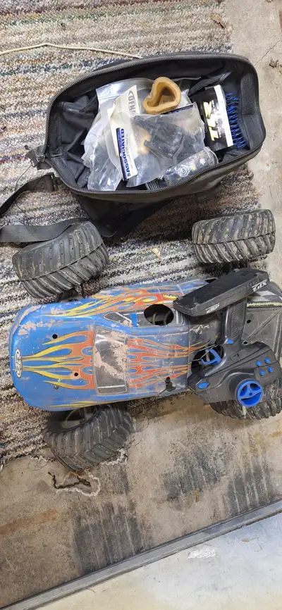 Monster gt nitro rc truck 1/8 scale. Bag full of spare parts, servos, differentials, shock parts, ge...