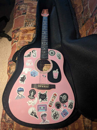 Pink guitar with a cover 