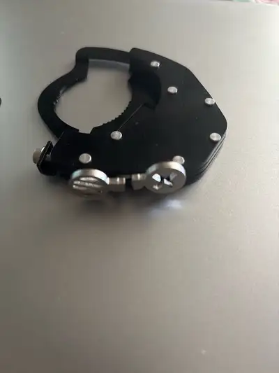 This is a motorcycle throttle lock, also known as a cruise control assist clamp. It's designed to he...