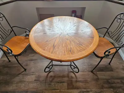 Selling dining room set. Round table, with leaf, and 4 chairs. Solid wood and metal construction. 42...