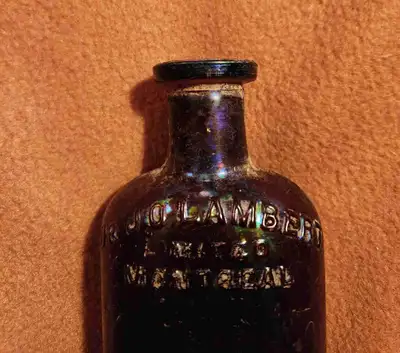 SI VOUS VOYEZ L'ANNONCE, C'EST ENCORE DISPONIBLE! Bouteille antique en verre brun de 5 po avec inscr...