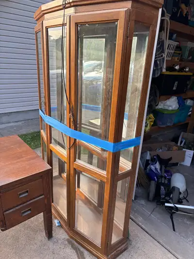 Classic wood and glass display cabinet with mirrored back and working interior light. Not a corner u...